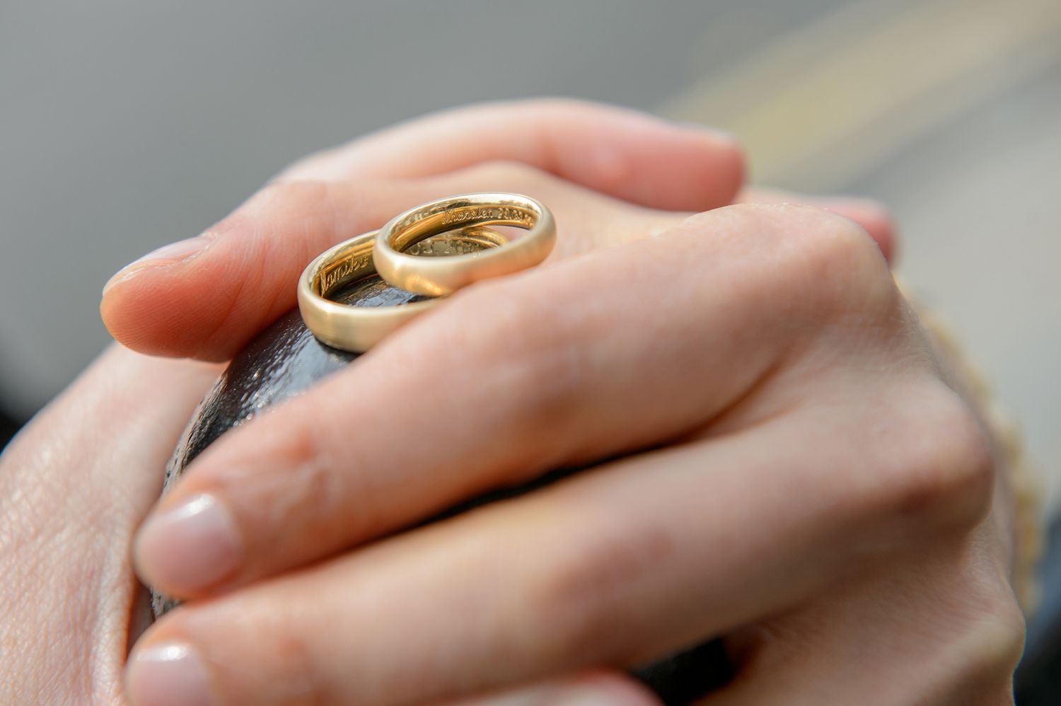 Close-up shots of wedding rings being exchanged during the ceremony.