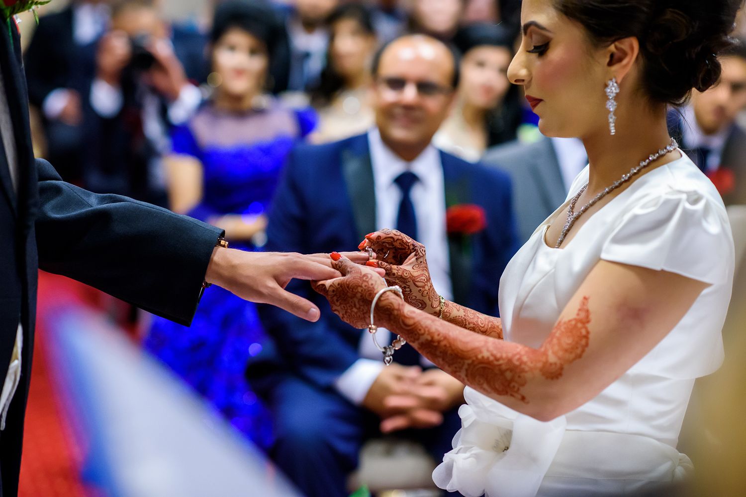 Traditional wedding ceremony rituals being performed with decorative elements and formal attire.