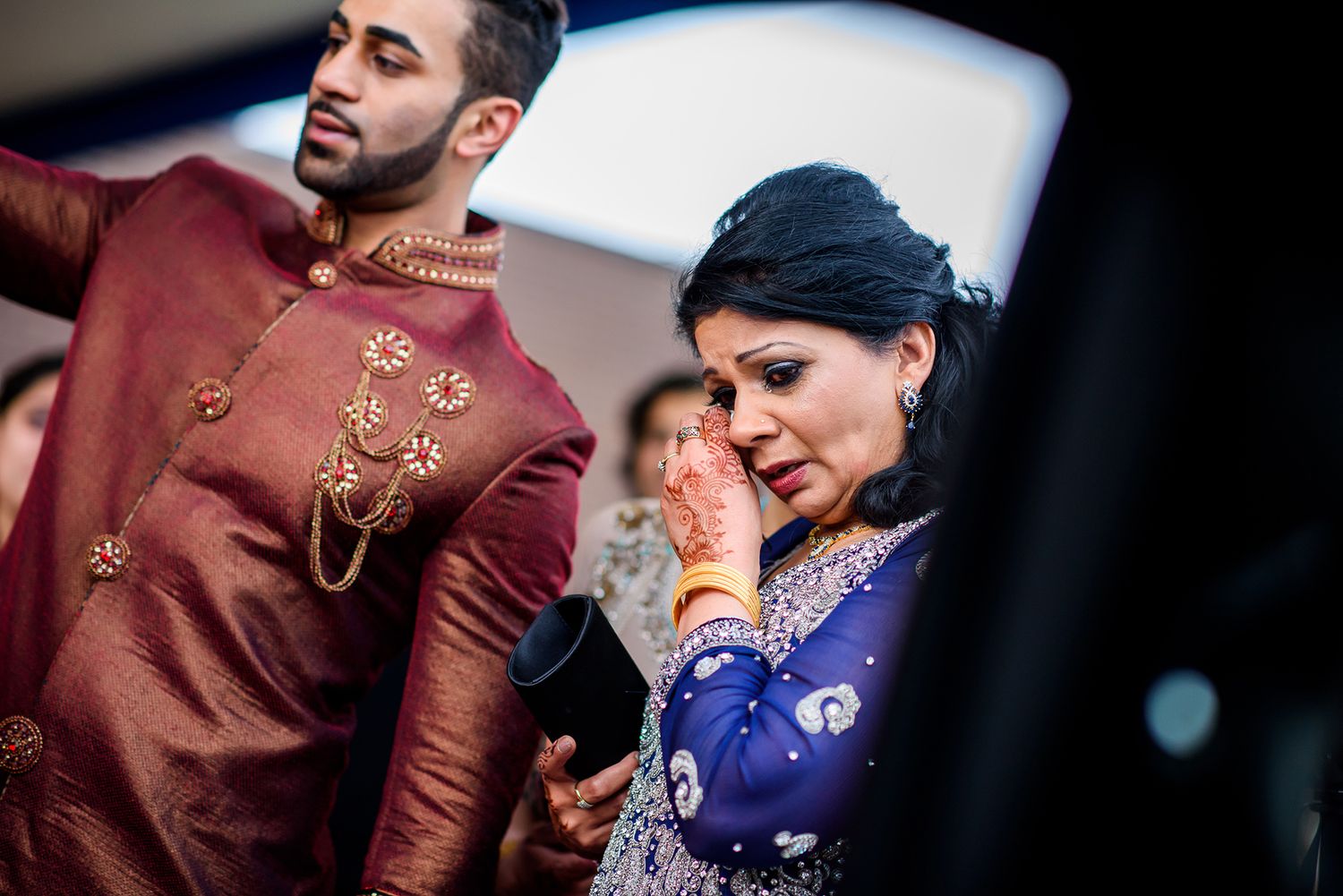 Wedding guests in traditional Indian attire during a formal ceremony.