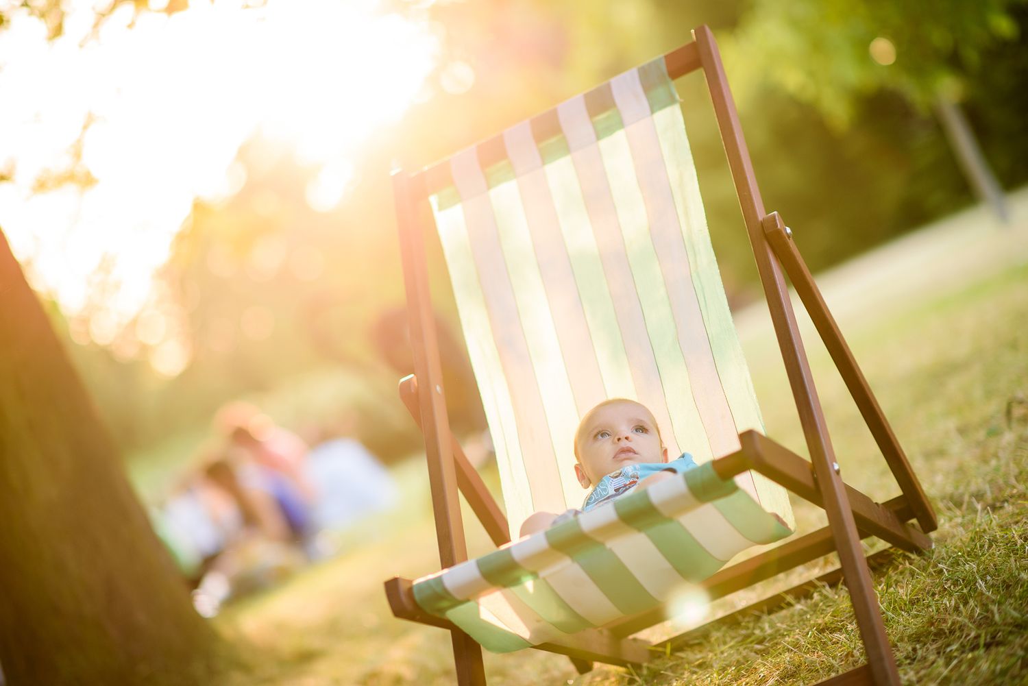 Outdoor seating arrangement with striped deck chairs in warm sunset lighting.