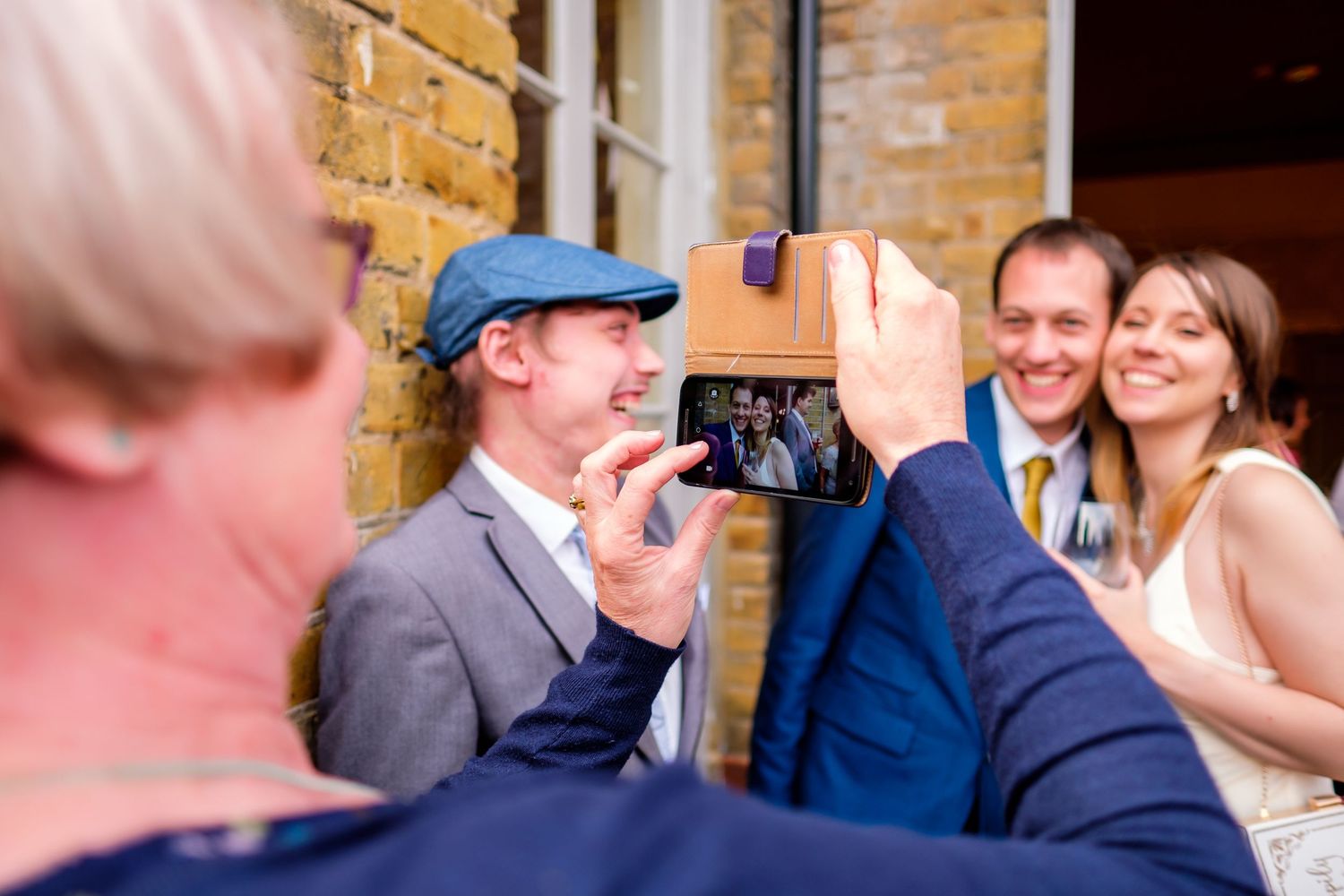 Casual moments captured during an outdoor brick venue wedding reception.
