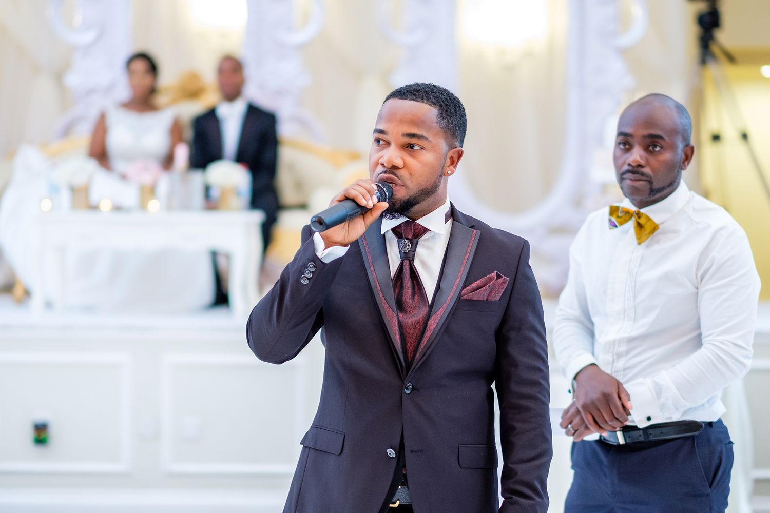 Wedding guests socializing at an elegant reception with formal decor.