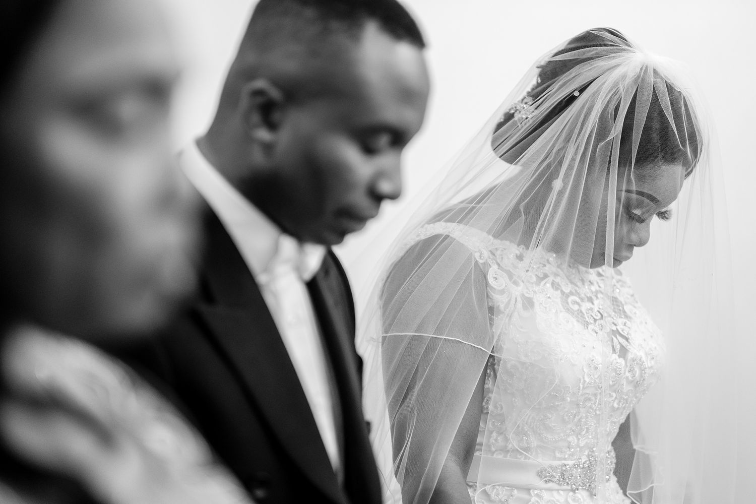 Candid black and white moments from an elegant wedding ceremony.