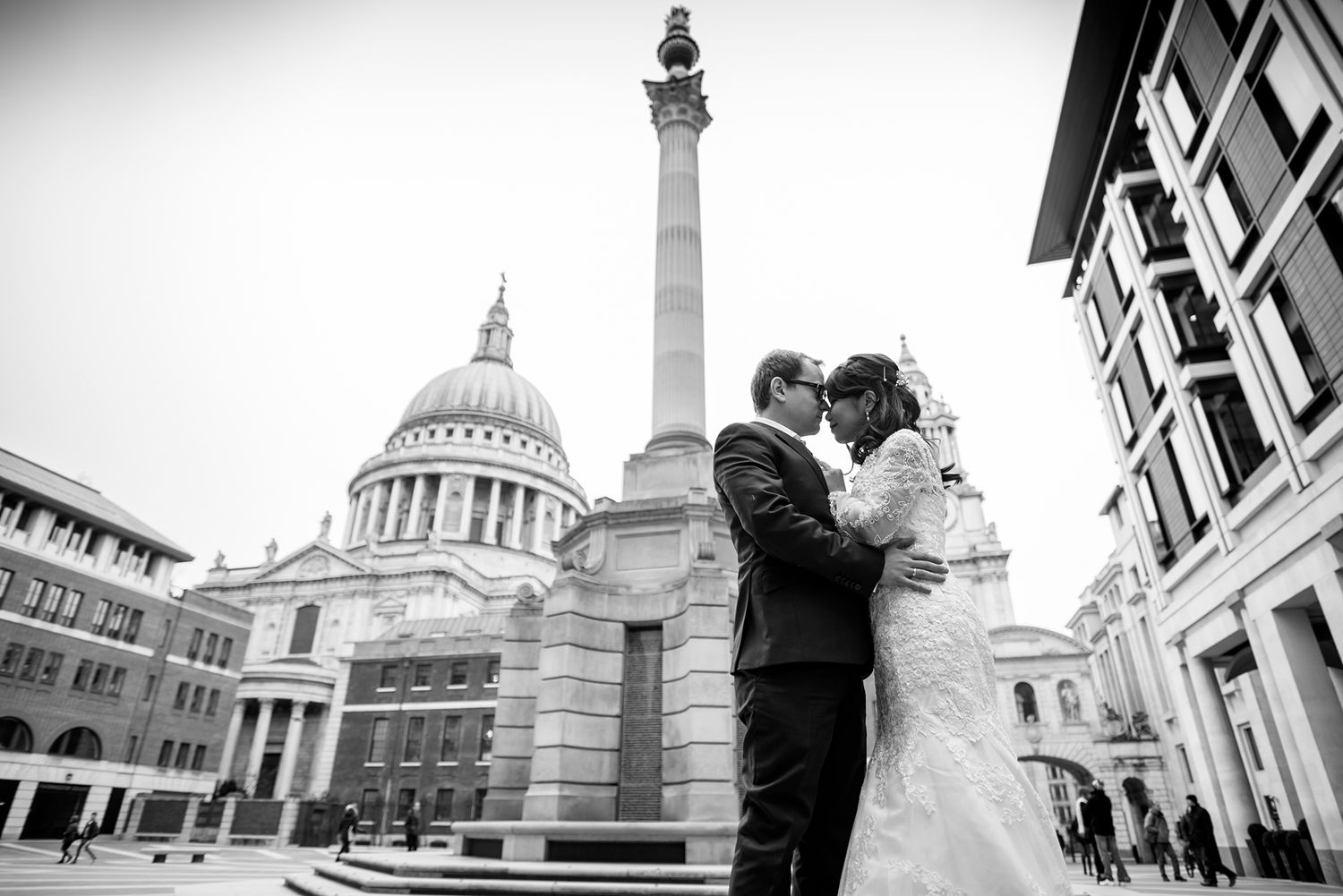 A dramatic black and white wedding photo with St Paul's Cathedral in the background.