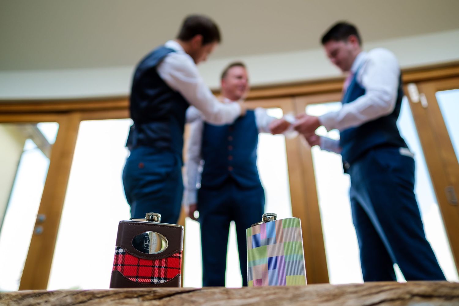 Groomsmen in formal attire preparing for wedding ceremony in blurred motion.