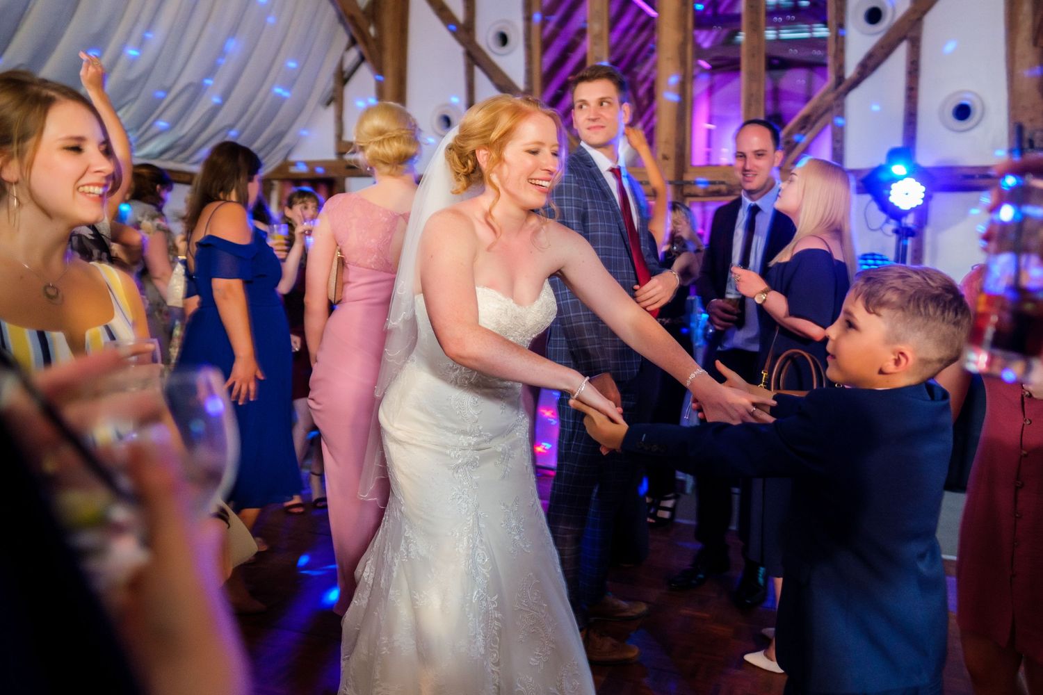 Wedding reception dance party with purple and blue lighting effects.