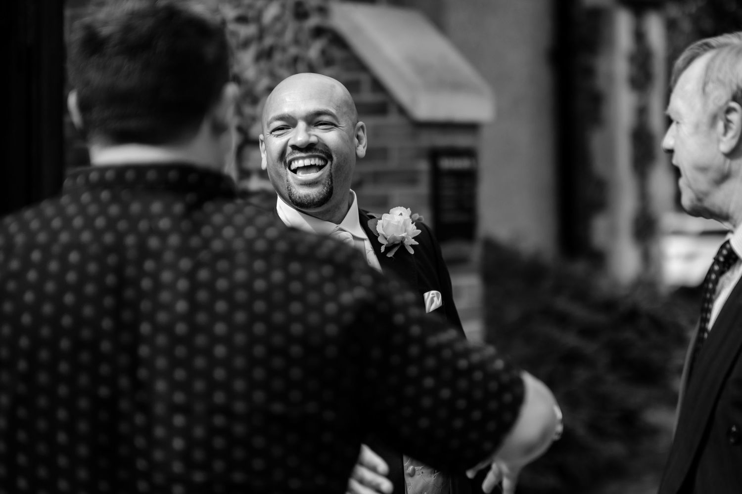 A series of black and white photographs showing people engaged in conversation and laughter.
