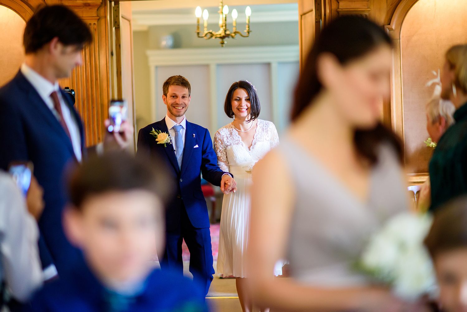 Couple shares joyful moment during elegant indoor wedding ceremony.