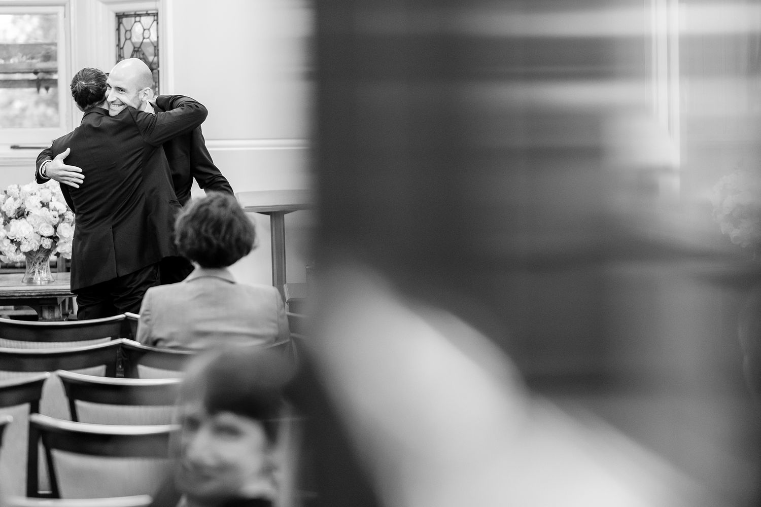 Blurred black and white images capturing motion and movement indoors.