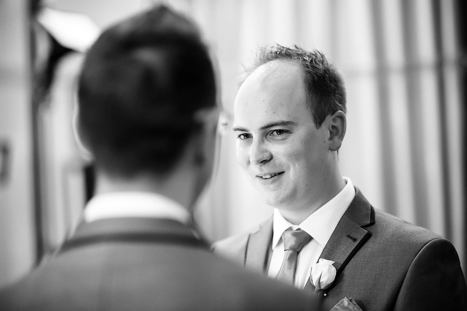 Classic black and white portrait shot of groomsmen preparing for wedding ceremony.
