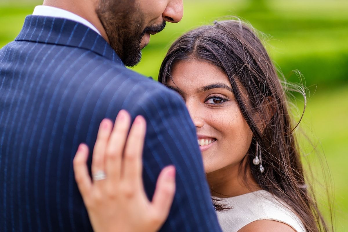 Close-up romantic moment captured between couple in formal wedding attire.