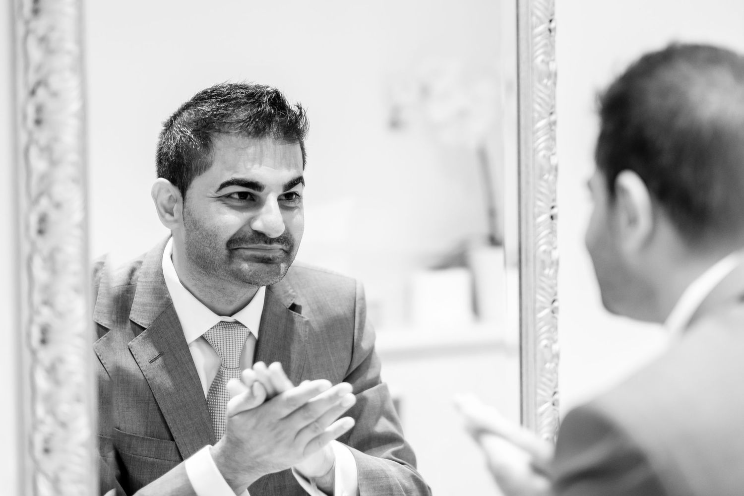 Black and white photos of preparation moments captured in mirror reflections.