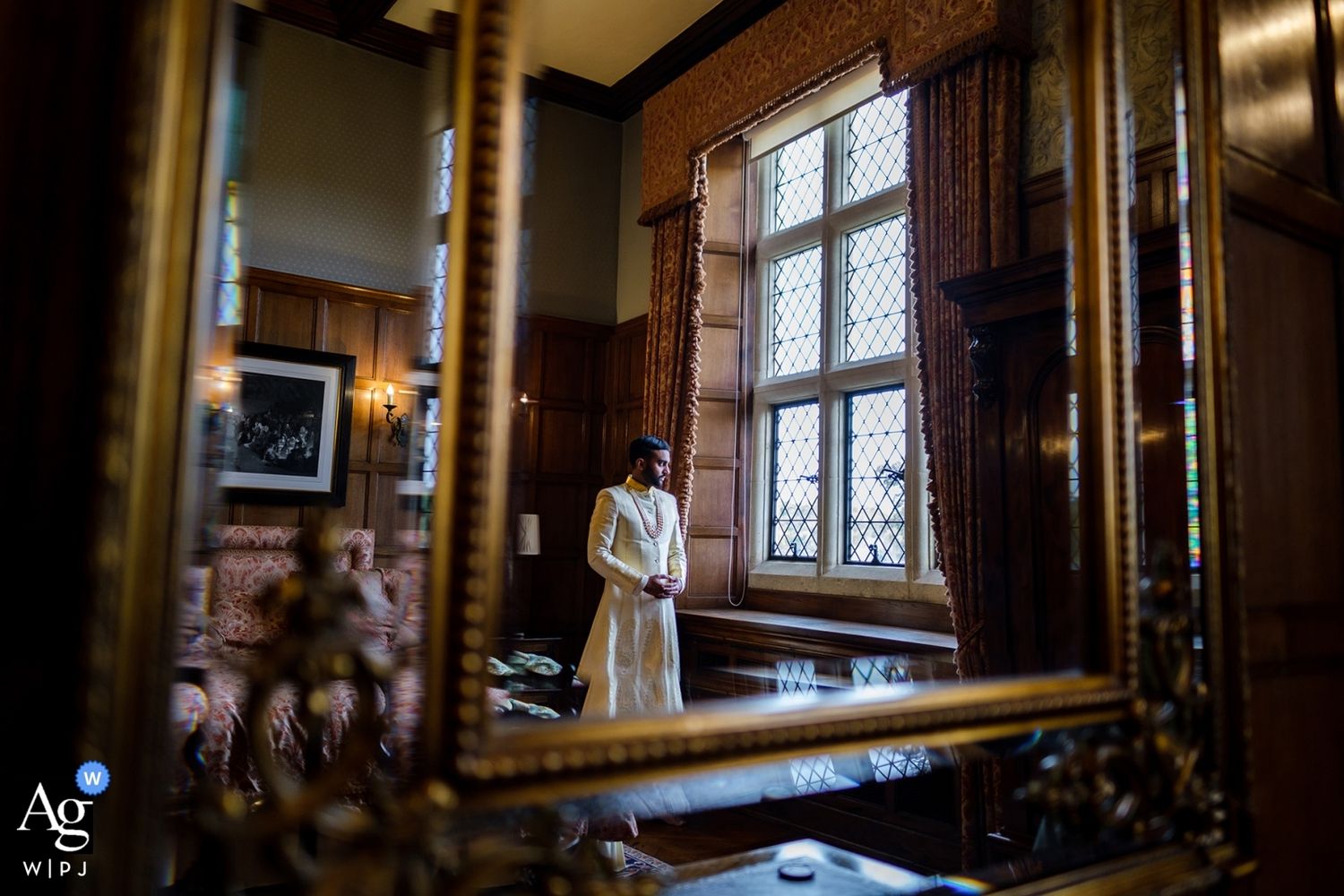 Interior view of historic venue with ornate windows and dark wood paneling.