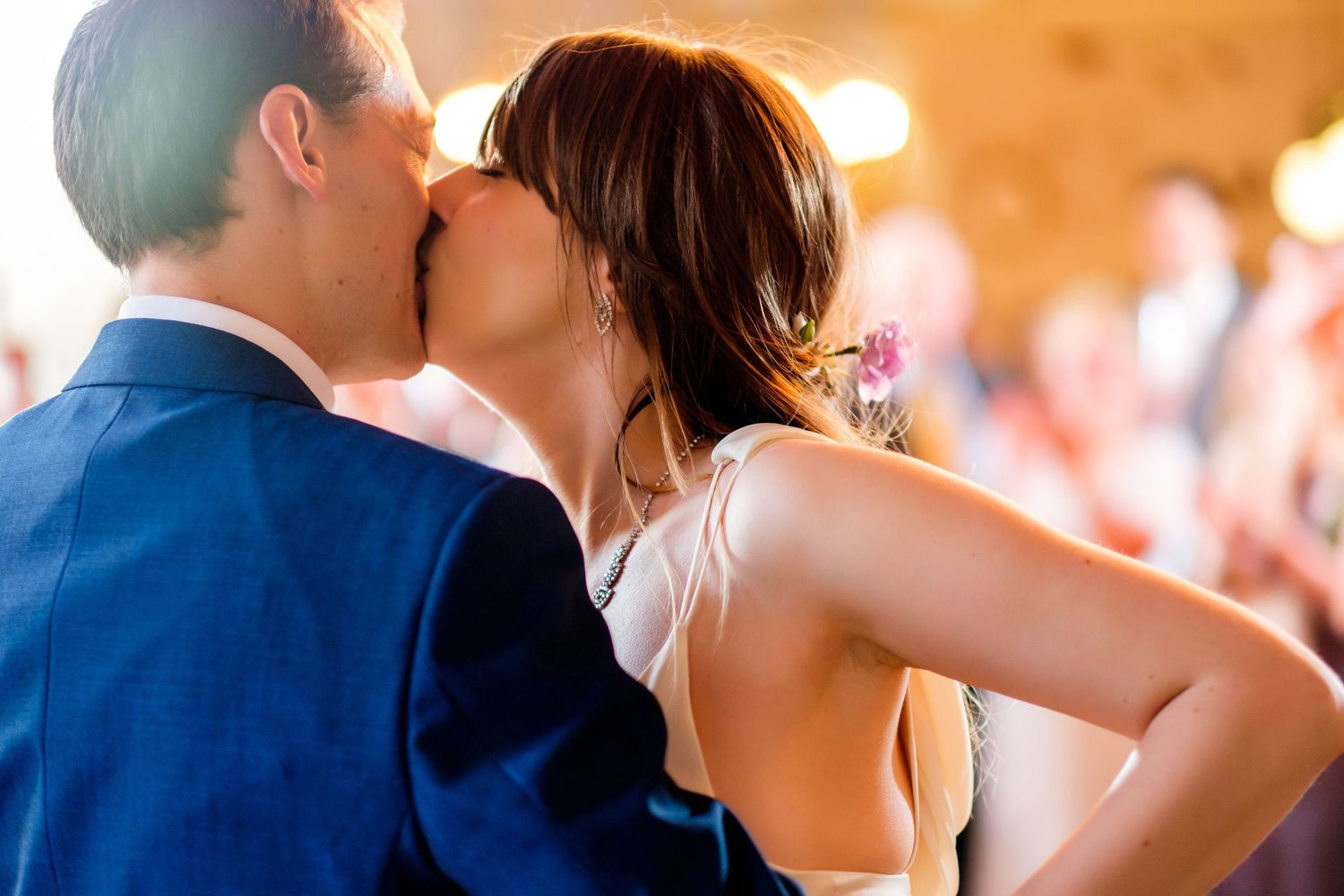 A romantic couple sharing a tender moment dancing together in a warm-lit setting.