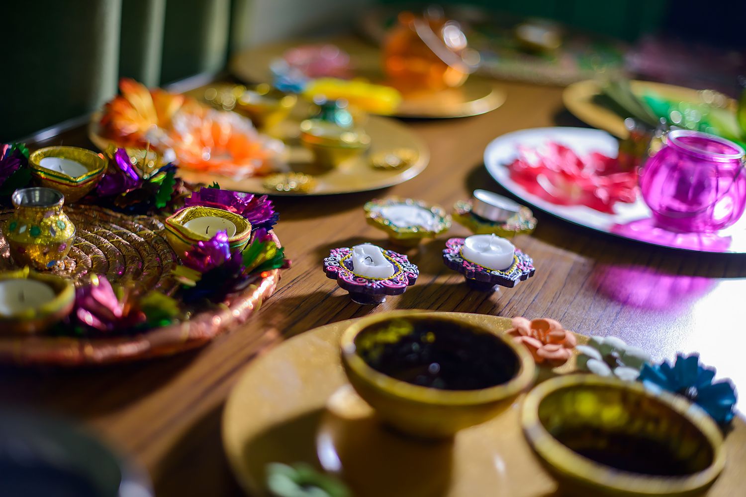 Colorful traditional Indian wedding items and decorations arranged on wooden table.