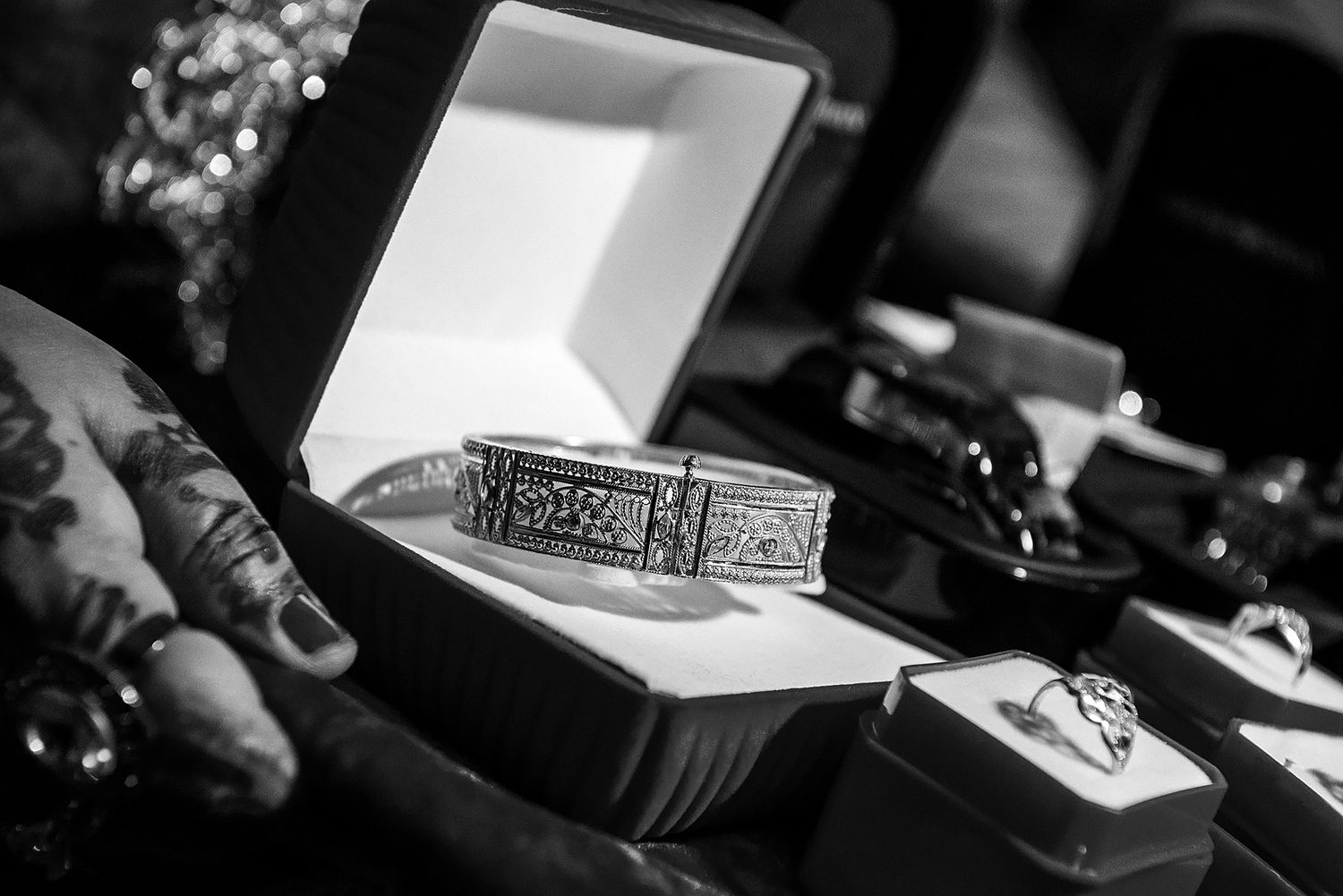 Black and white detail shot of wedding ceremony items and decorative elements.
