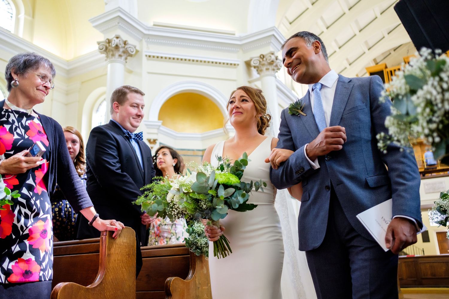 Wedding celebration moments captured in an elegant venue with ornate architectural details.