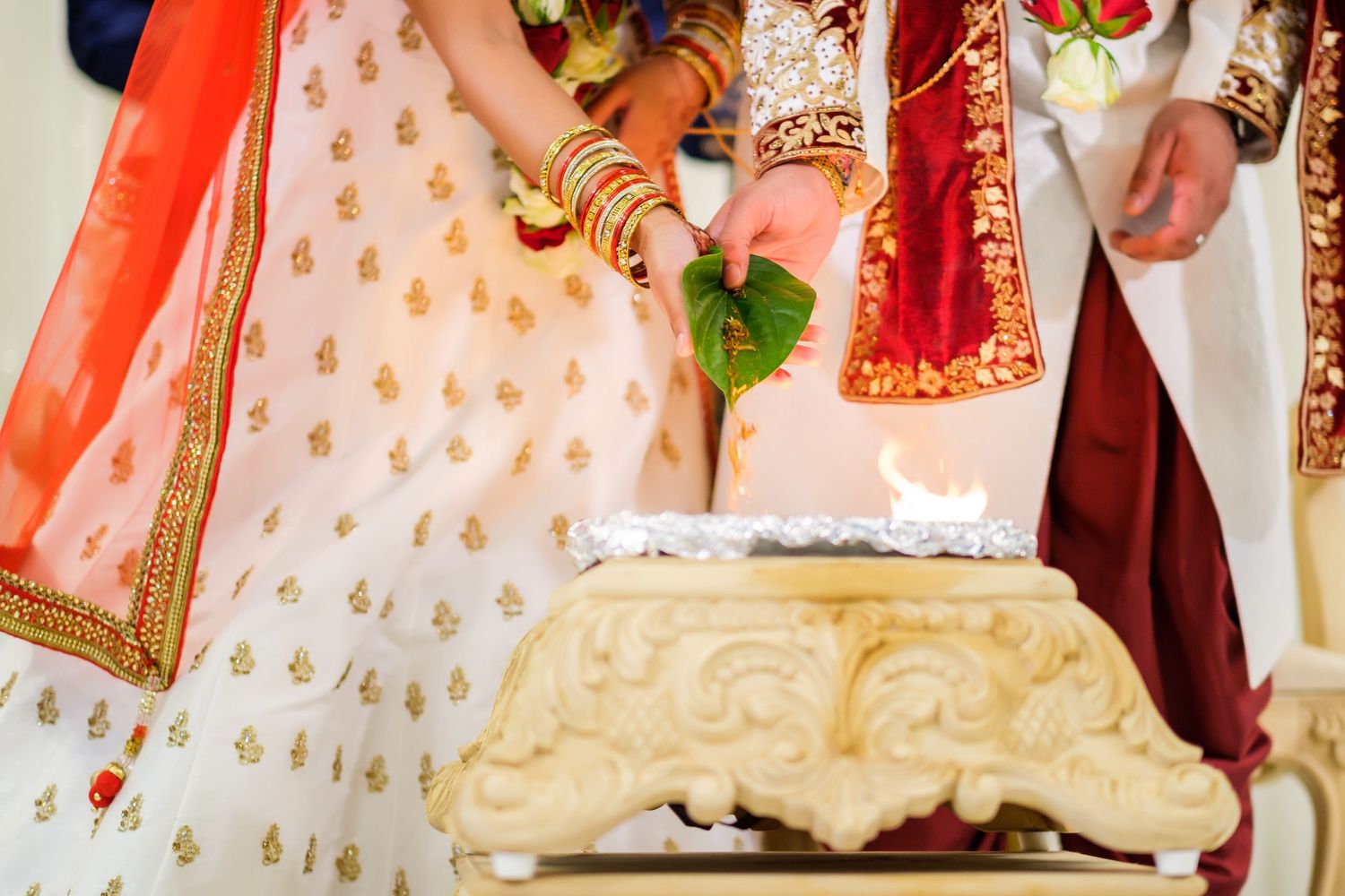 Traditional Indian wedding ceremony with ornate gold and red decorations.
