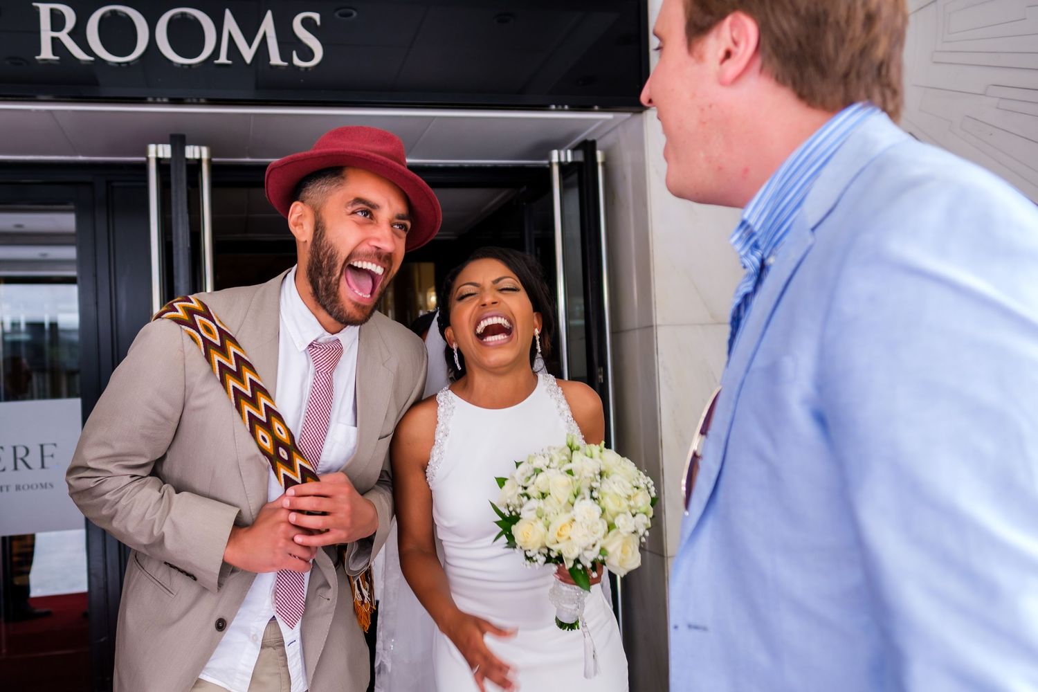 Guests enjoying drinks and conversation during an outdoor wedding reception.