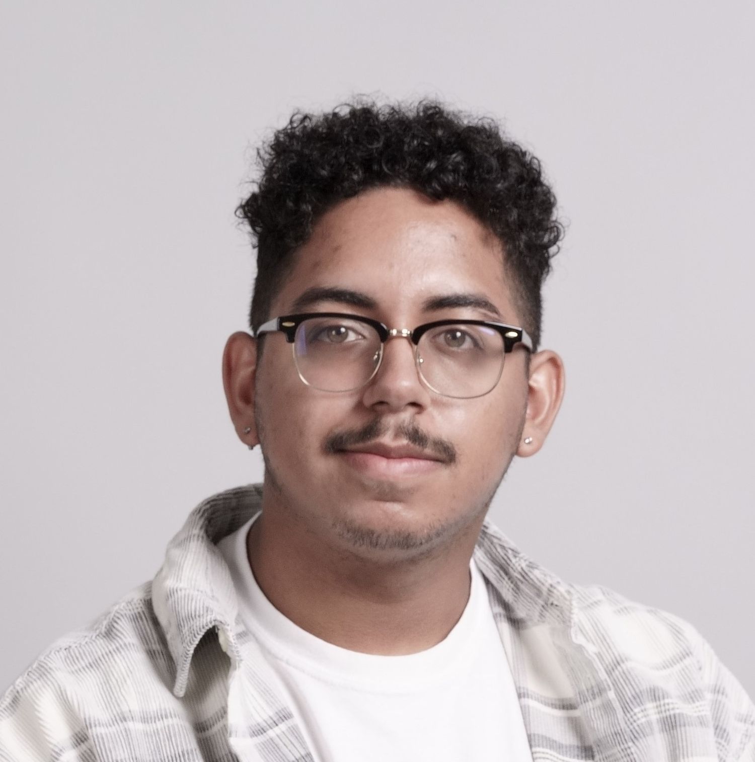 A composition of multiple headshots showing a person in a white shirt from slightly different angles and expressions.