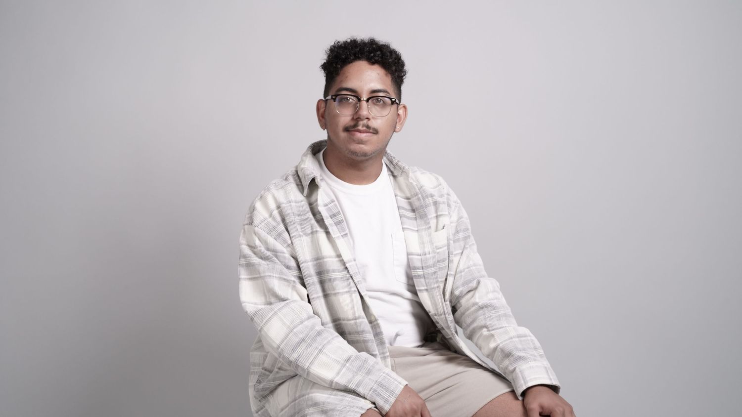 Professional portrait series against light gray background showing different poses.