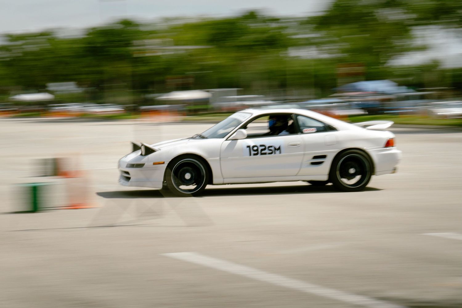 White Mercedes-Benz SLK competing in autocross event with number 192SM on door panel.