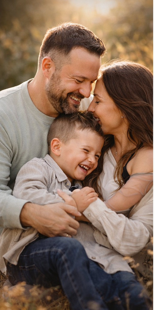 A happy family shares joyful moments together during an outdoor autumn photoshoot at golden hour.