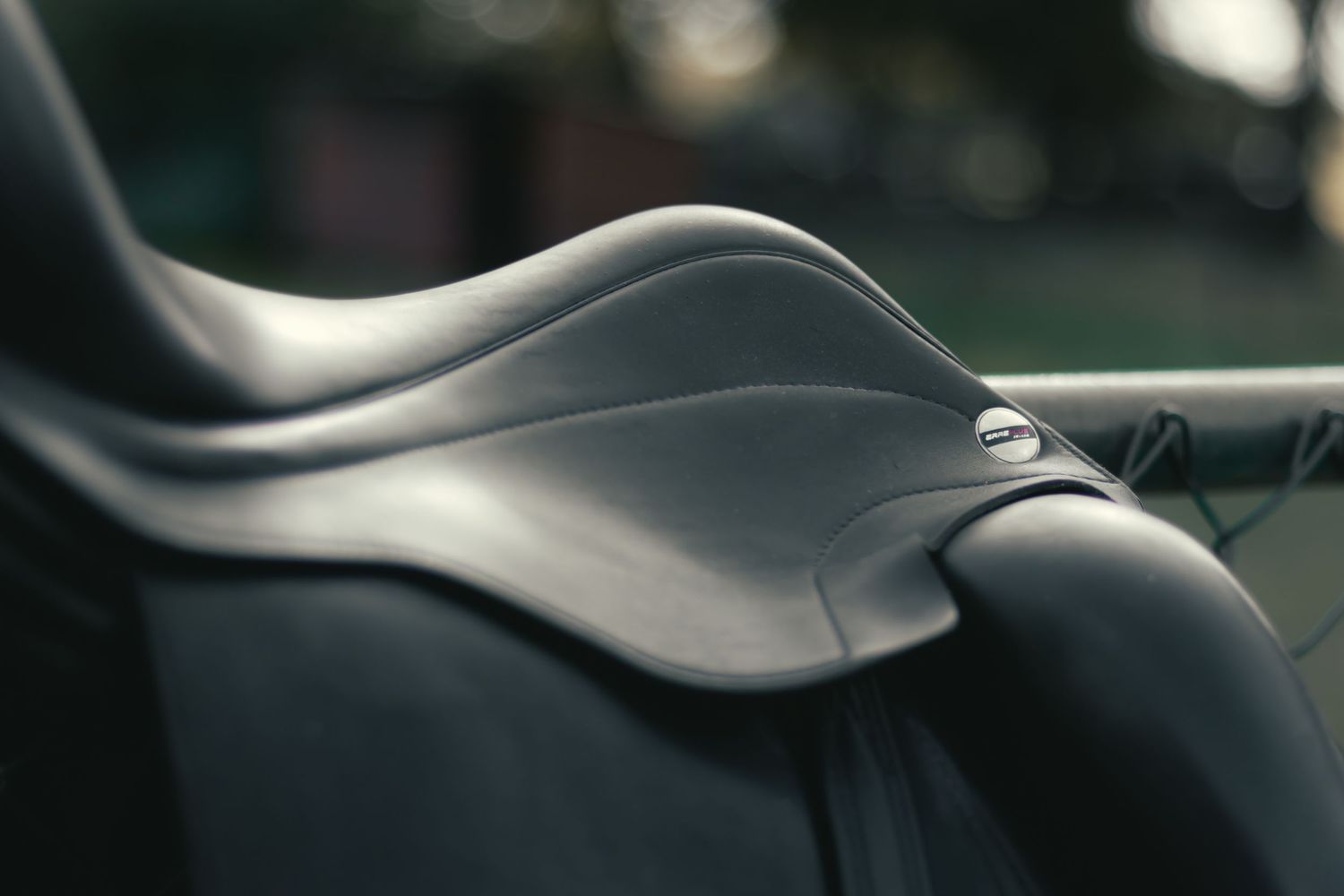 Close-up view of gently waving abstract black and silver metallic curves forming an elegant geometric pattern.