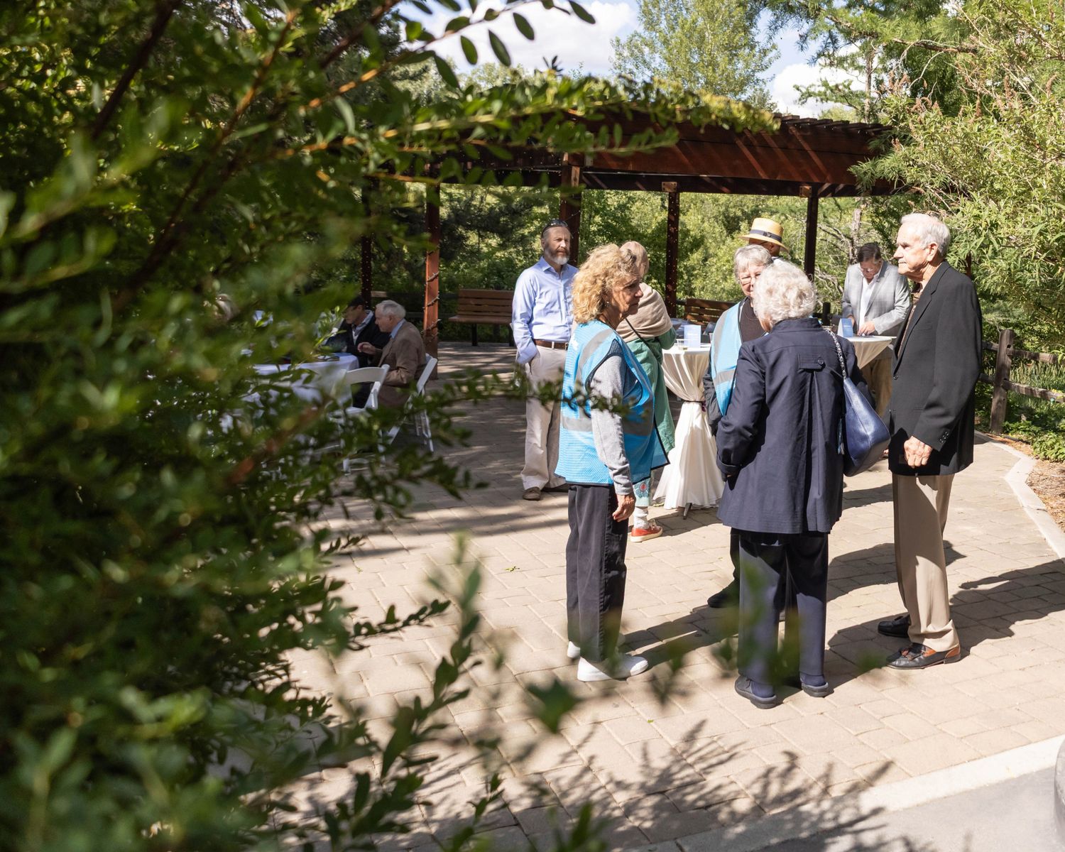 People talking near a cocktail table at an event