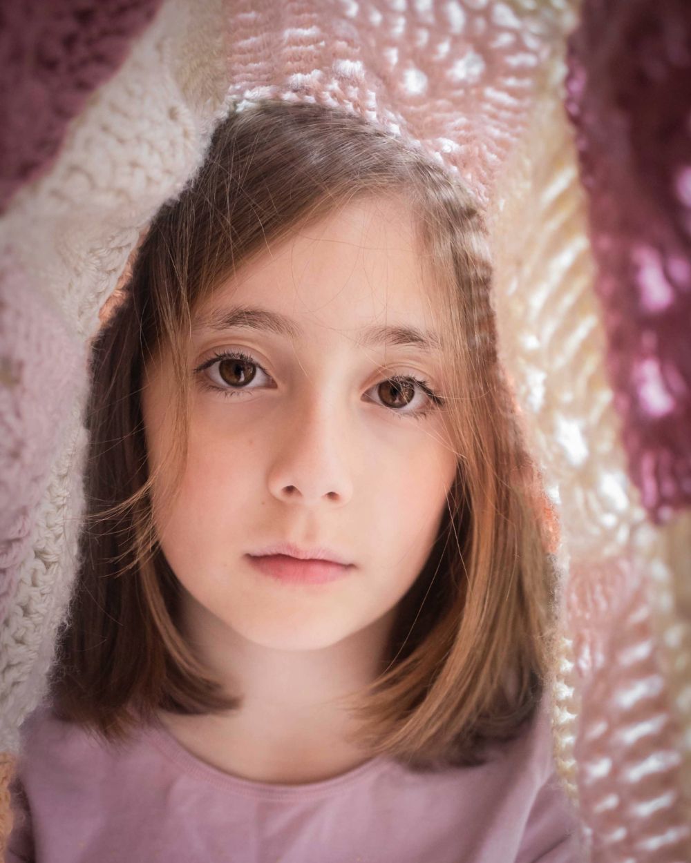 Portrait of girl with a blanket over her head