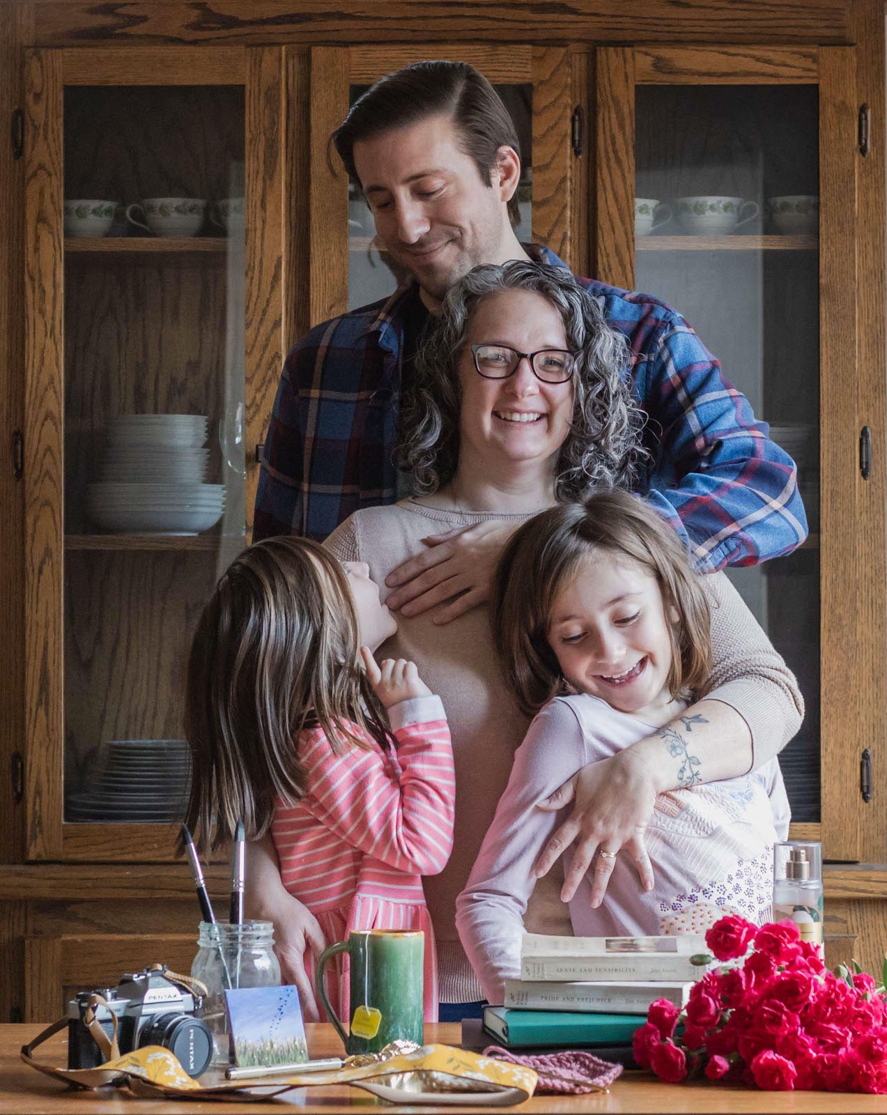 Smiling family poses for picture in kitchen