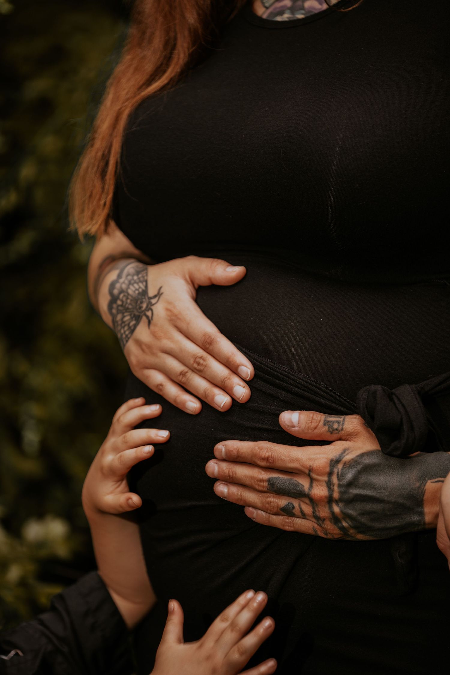Close-up shots of hands with tattoos and rings against a dark background in various intimate poses.