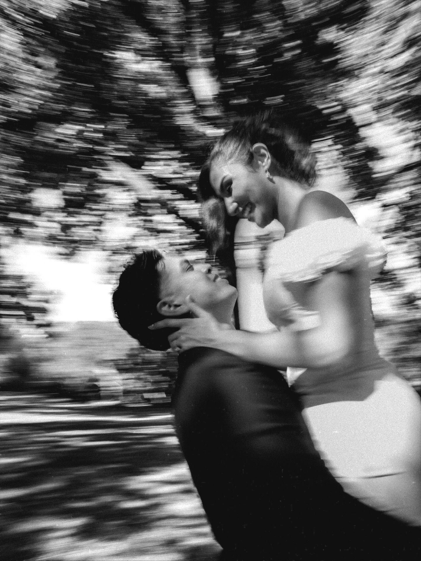 Dynamic black and white sequence of a spinning dance move in a natural setting.