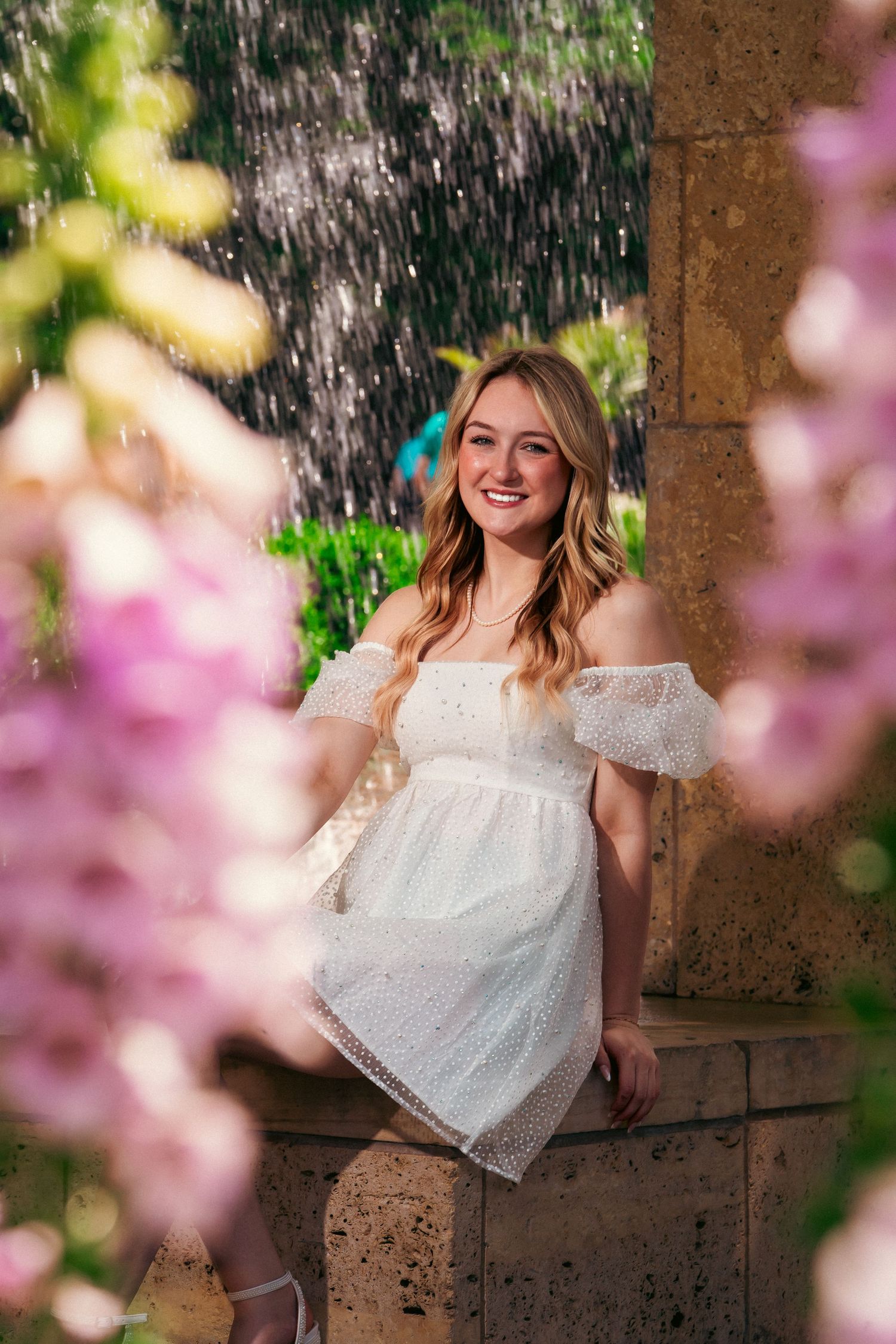 A spring portrait session featuring white lace dress and cherry blossoms in soft natural lighting.