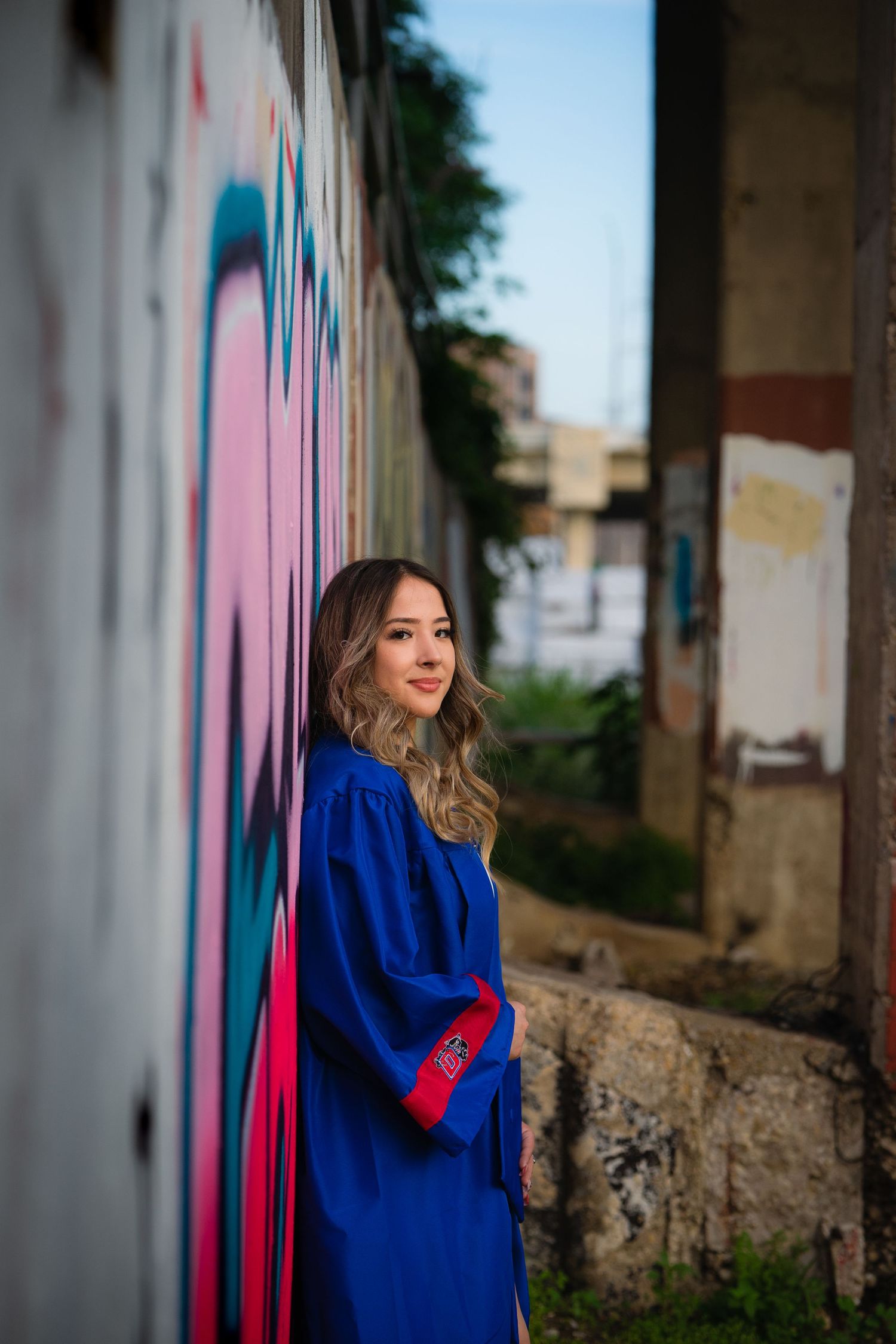 Series of artistic portraits against a colorful graffiti wall featuring a bright blue outfit with red accents.
