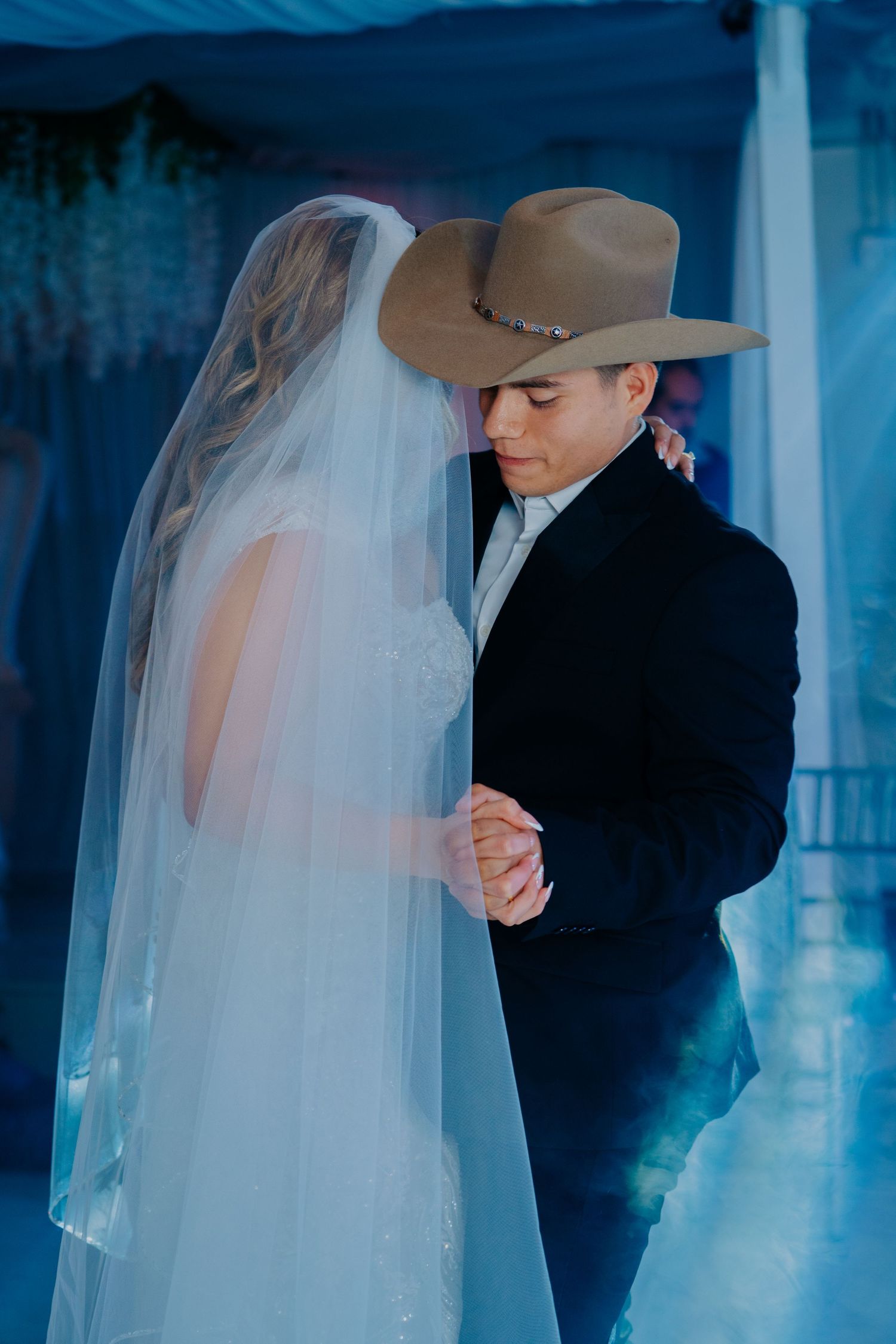A romantic wedding photoshoot sequence showing the couple in silhouette against a dreamy blue background.
