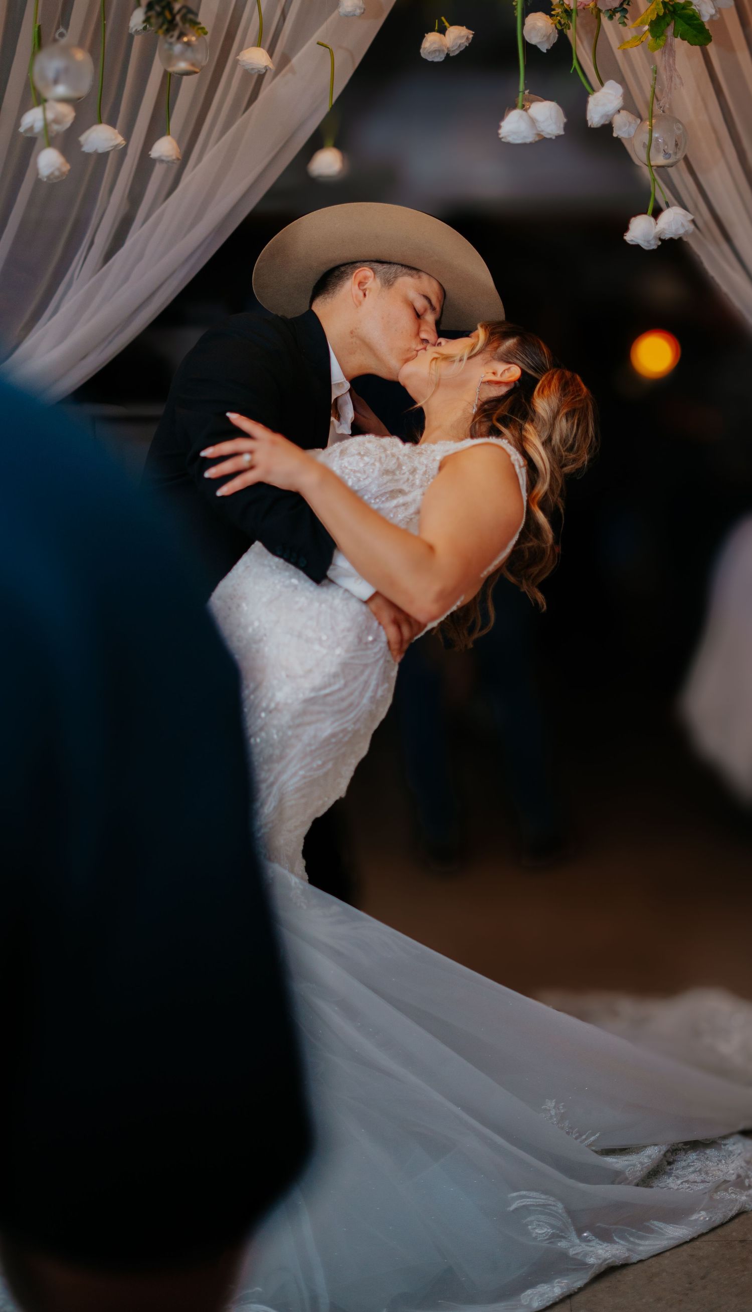 Romantic dance sequence at a wedding reception with string lights and white drapery creating an intimate atmosphere.