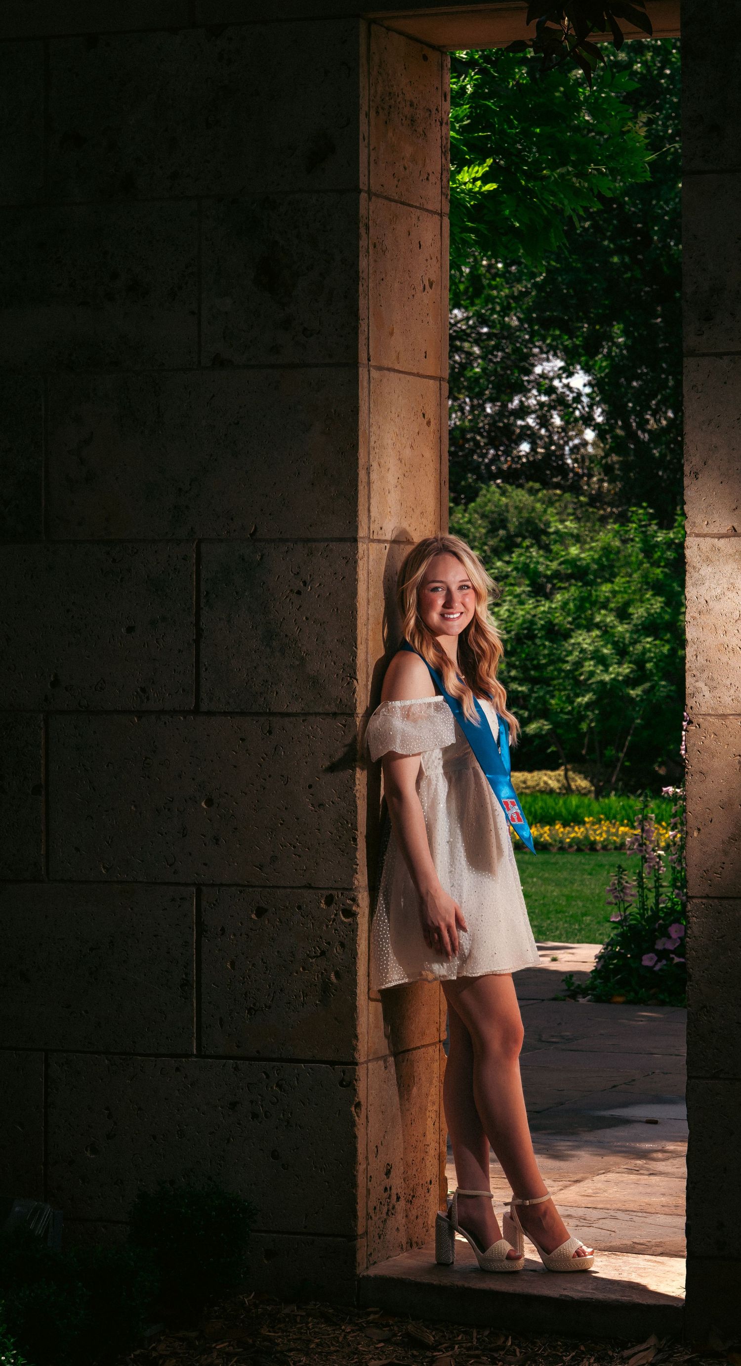 Artistic outdoor photo sequence featuring someone in a white dress standing in the shadows of stone pillars.