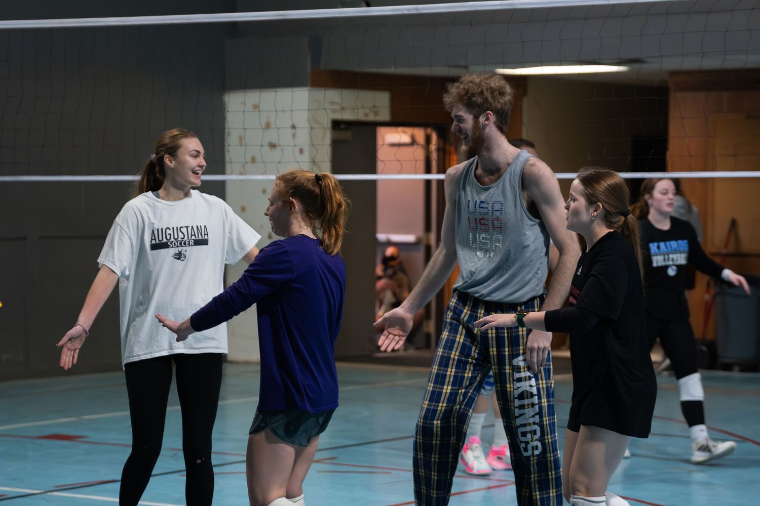 Group of people practicing moves in a sports facility.
