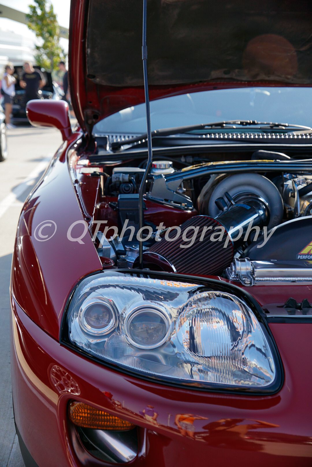 Close-up shots of red sports car headlights and engine bay details.
