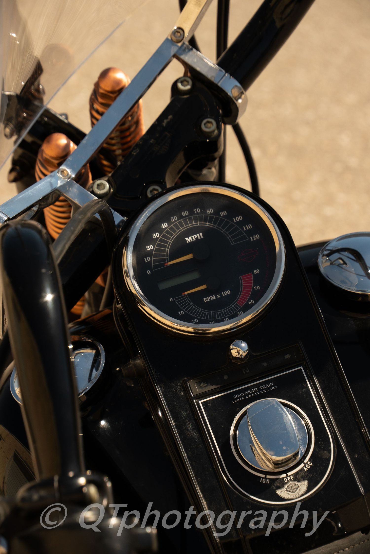 Close-up detail shots of vintage motorcycle gauges and instruments in black.