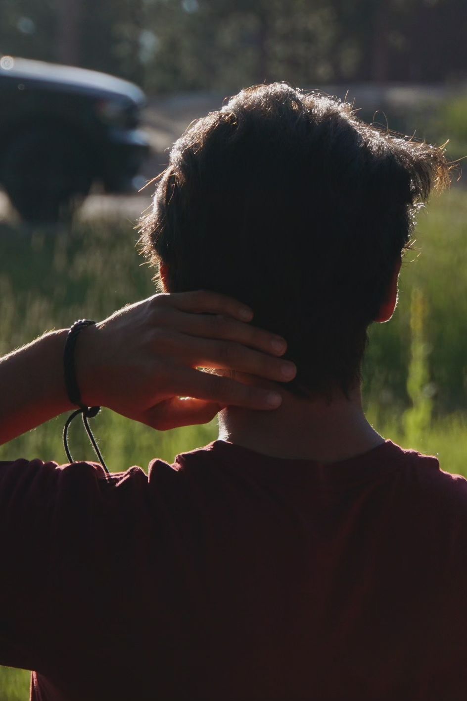 Silhouette of a person's head against sunlit background with hand gestures shown in progressive motion frames.