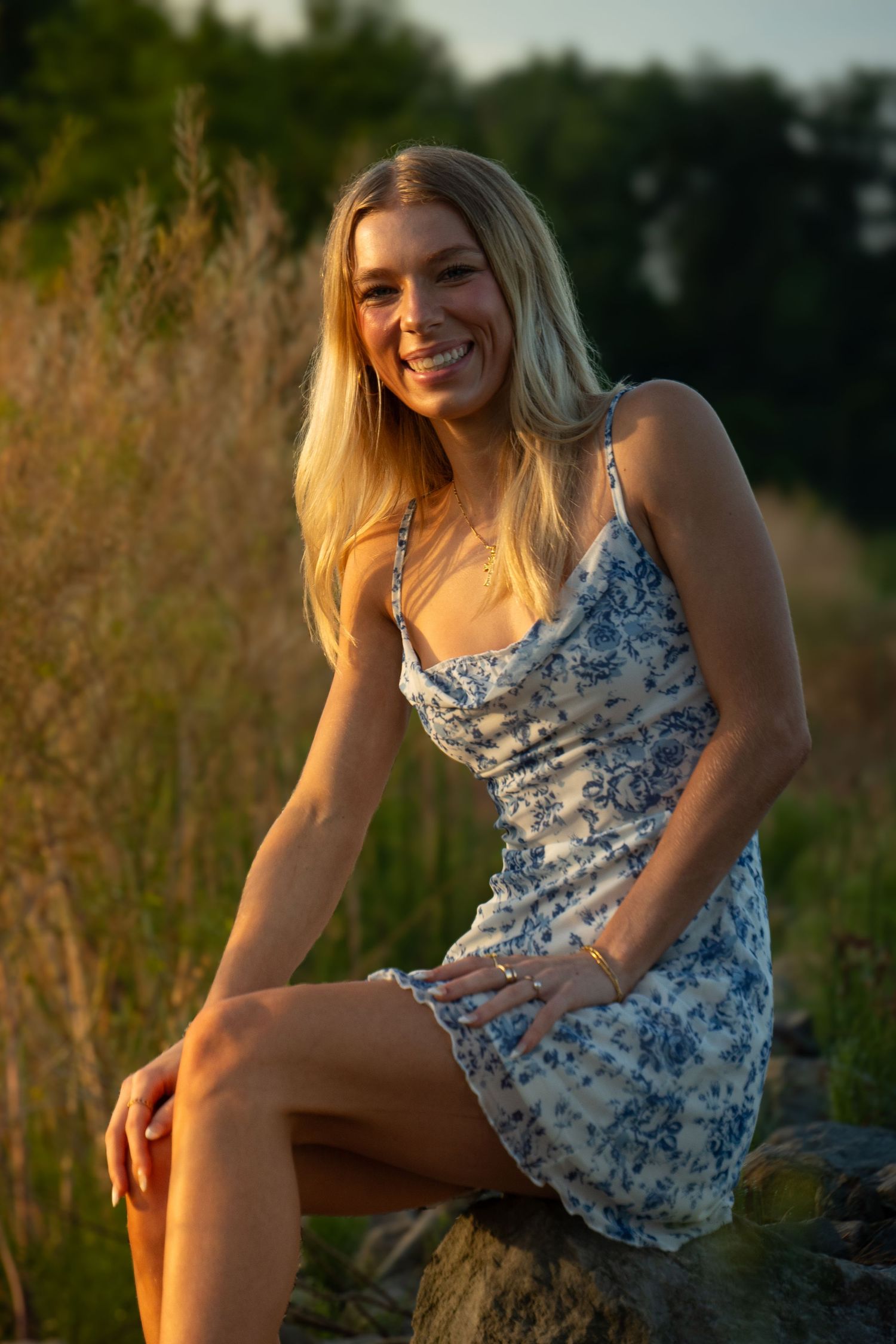 Outdoor portrait in floral dress during golden hour sunset.
