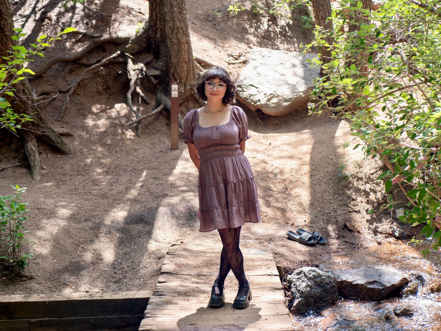 A sequence of hiking trail photos showing a person walking along a shaded dirt path surrounded by greenery and rocks.