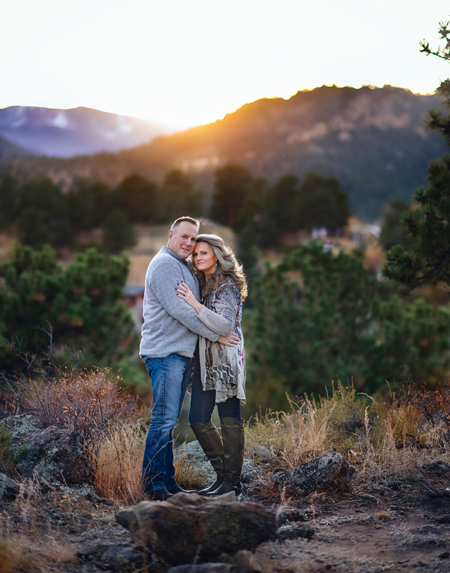 A romantic sunset scene in the mountains with tall grass and natural lighting.