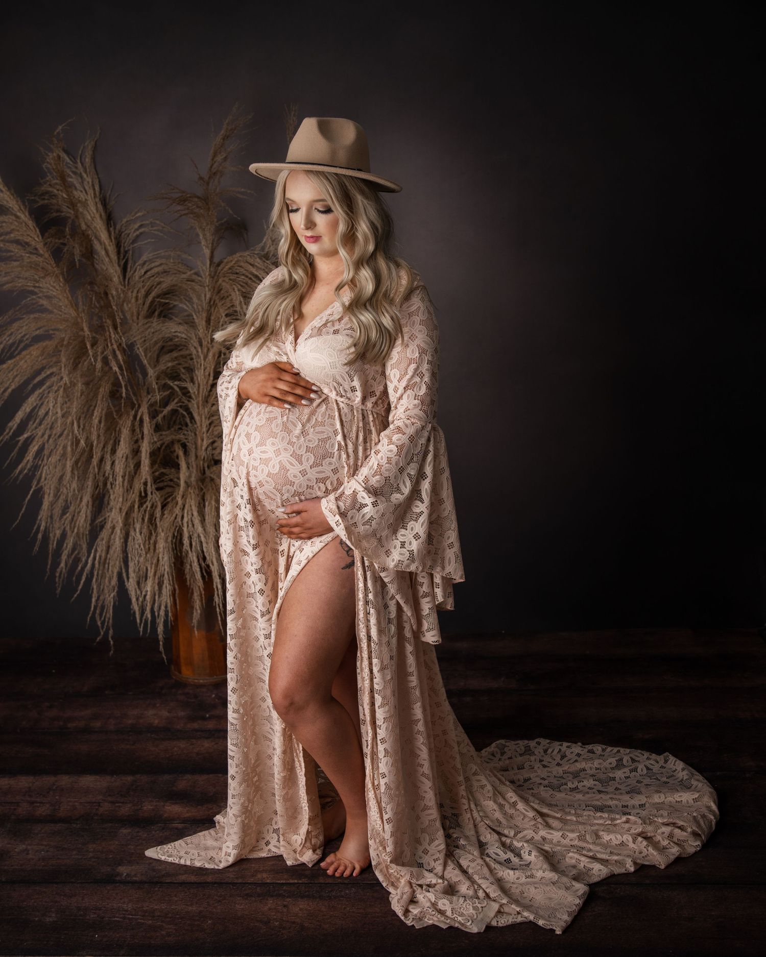 Maternity portrait featuring sparkly rose gold robe and dramatic lighting.