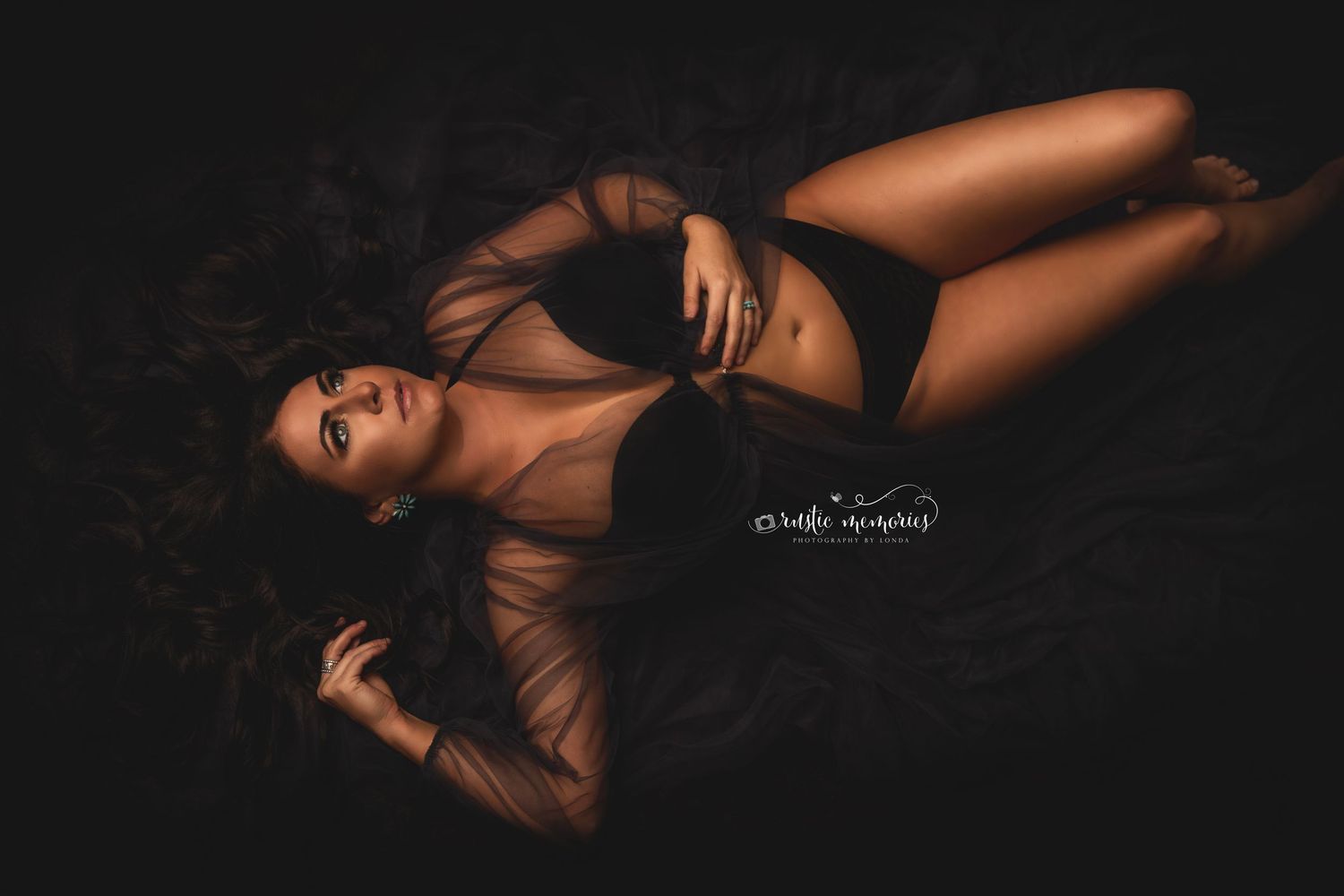 Artistic boudoir photography series with dark dramatic lighting against black background.
