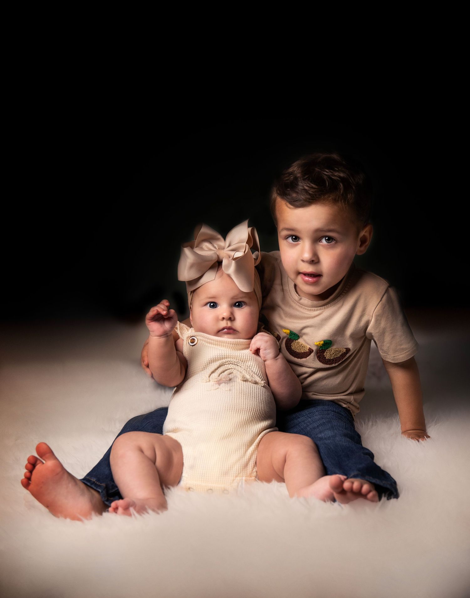 A soft studio portrait on a light backdrop.