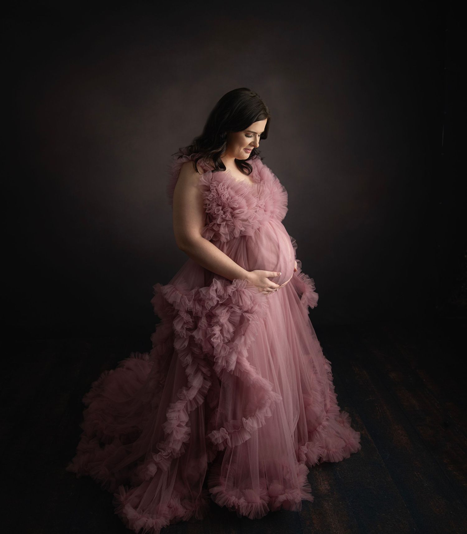 Professional photography series with a voluminous dusty rose tulle dress in dramatic lighting.