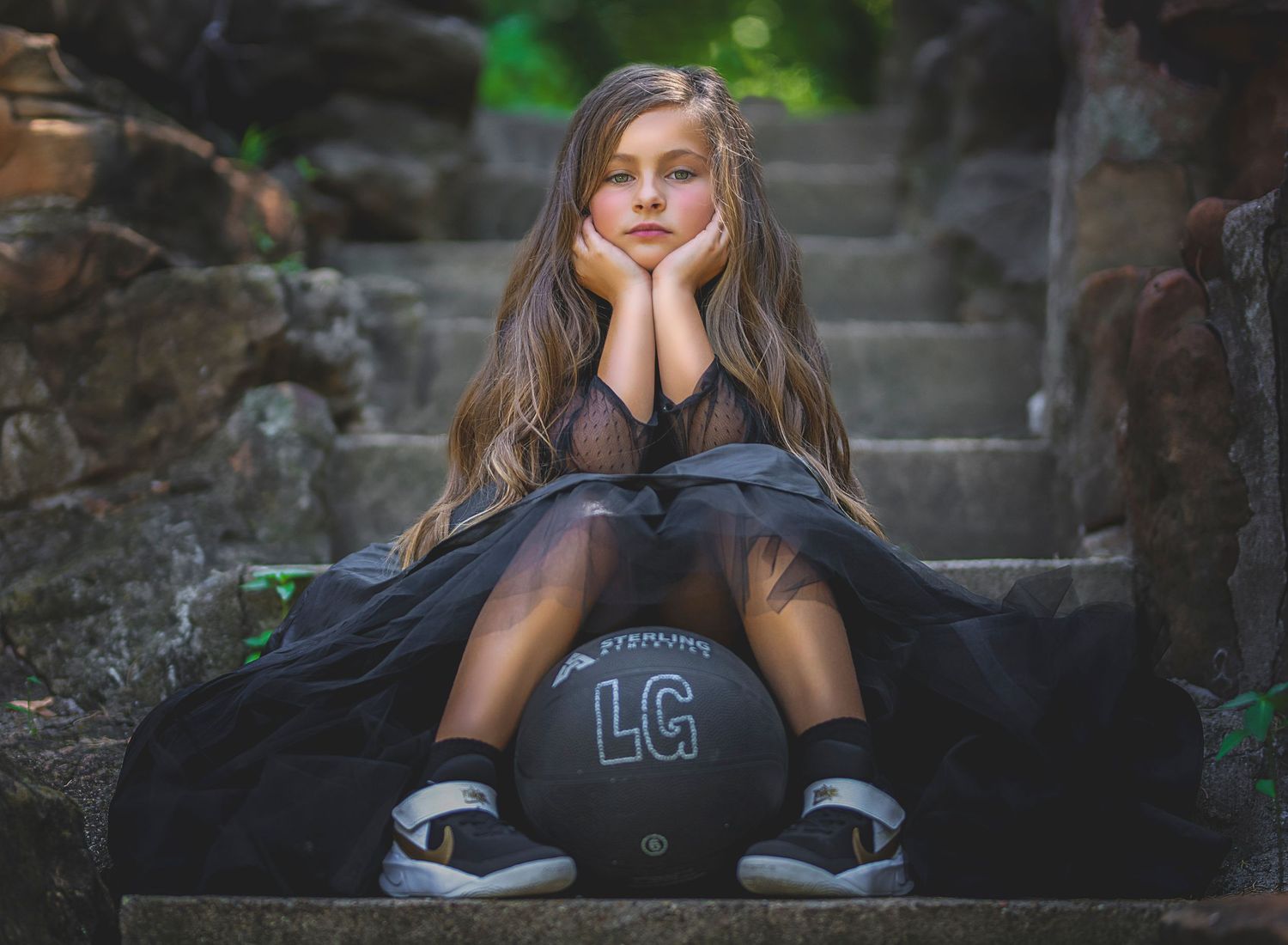 Moody portrait series on stone steps featuring casual athletic wear and relaxed poses.